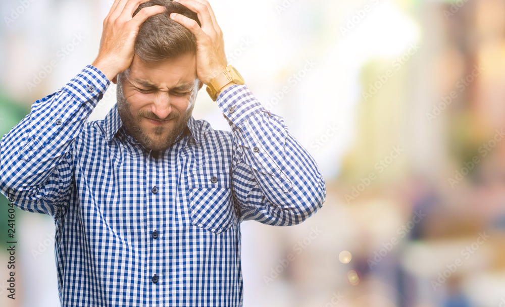 Obraz premium Young handsome man over isolated background suffering from headache desperate and stressed because pain and migraine. Hands on head.