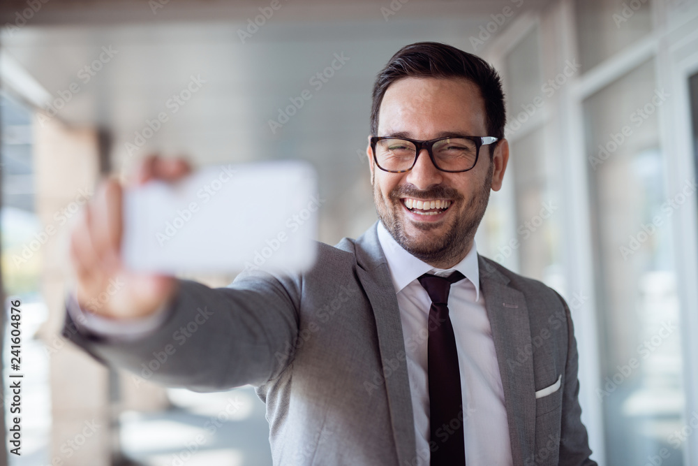 Happy businessman taking selfie outdoors. Selective focus on th face. Happy businessman taking selfie outdoors. Selective focus on th face.