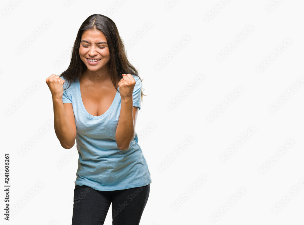 Young beautiful arab woman over isolated background very happy and excited doing winner gesture with arms raised, smiling and screaming for success. Celebration concept. Young beautiful arab woman over isolated background very happy and excited doing winner gesture with arms raised, smiling and screaming for success. Celebration concept.