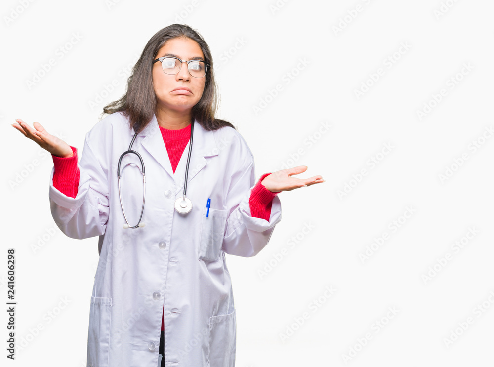Young arab doctor woman over isolated background clueless and confused expression with arms and hands raised. Doubt concept. Young arab doctor woman over isolated background clueless and confused expression with arms and hands raised. Doubt concept.