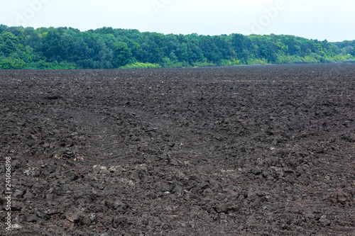 plowed agricultural field with black earth soil