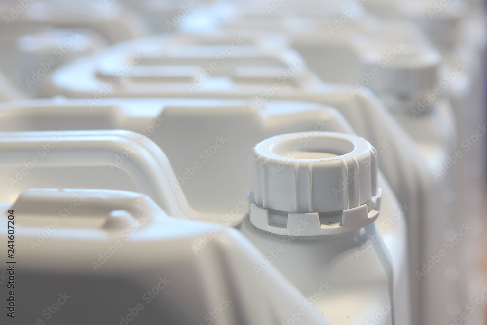 Canisters for liquid of white color from plastic. Empty canisters for