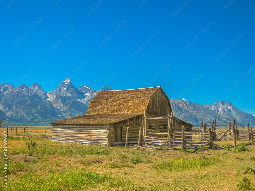 Moulton Barn in Antelope Flats at Grand Teton NP, Wyoming, United States. Popular landmark in the national park. North America travel in summer season. Blue sky with copy space. Moulton Barn in Antelope Flats at Grand Teton NP, Wyoming, United States. Popular landmark in the national park. North America travel in summer season. Blue sky with copy space.