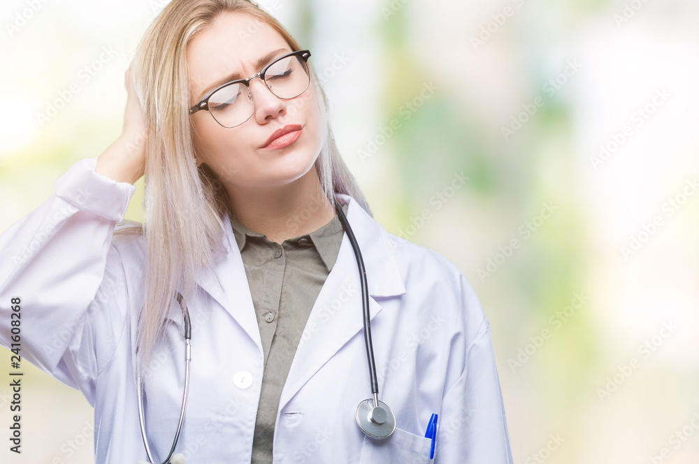 Young blonde doctor woman over isolated background confuse and wonder about question. Uncertain with doubt, thinking with hand on head. Pensive concept. Young blonde doctor woman over isolated background confuse and wonder about question. Uncertain with doubt, thinking with hand on head. Pensive concept.