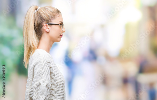 Young beautiful blonde woman wearing glasses over isolated background looking to side, relax profile pose with natural face with confident smile.