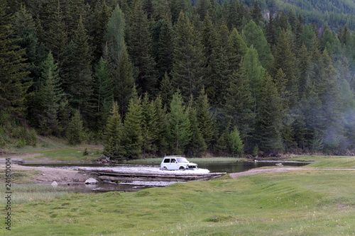 The car is shipped through the mountain river near the village of Aktash in the Ulagan district of the Altai Republic photo