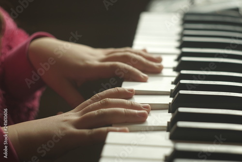 Keyboard Electronic Piano And Playing Child Hands.