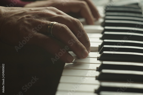 Man Playing piano close up
