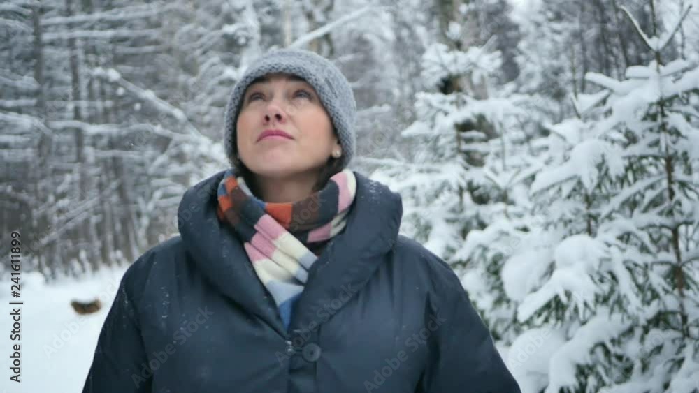 Beautiful woman walks through a snowy forest and enjoys the weather. Calm and meditative shot. Slow motion Beautiful woman walks through a snowy forest and enjoys the weather. Calm and meditative shot. Slow motion