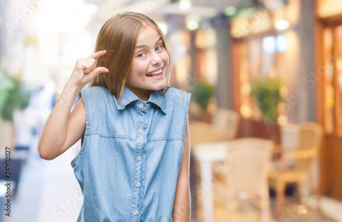 Wallpaper Mural Young beautiful girl over isolated background smiling and confident gesturing with hand doing size sign with fingers while looking and the camera. Measure concept. Torontodigital.ca