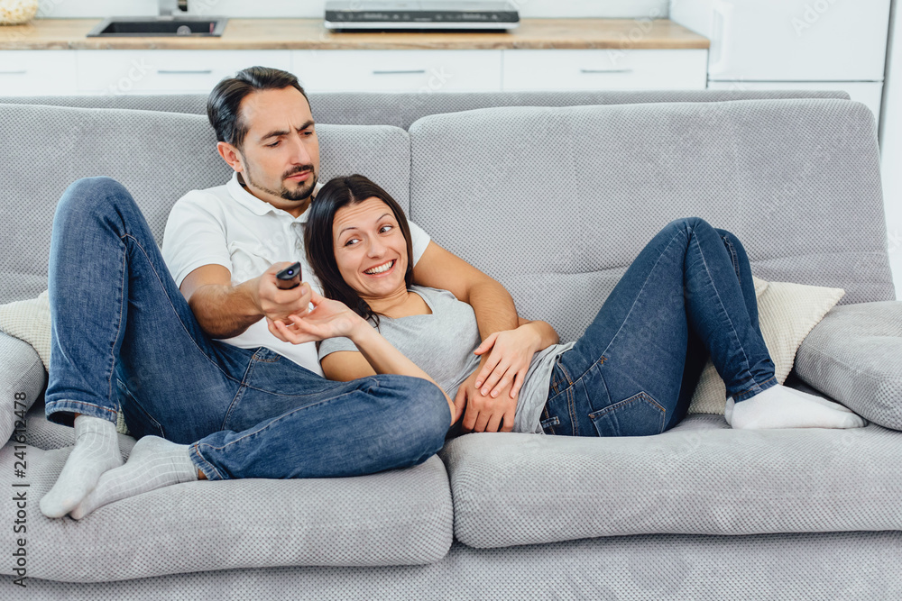 Husband and wife sitting on a sofa Husband and wife sitting on a sofa