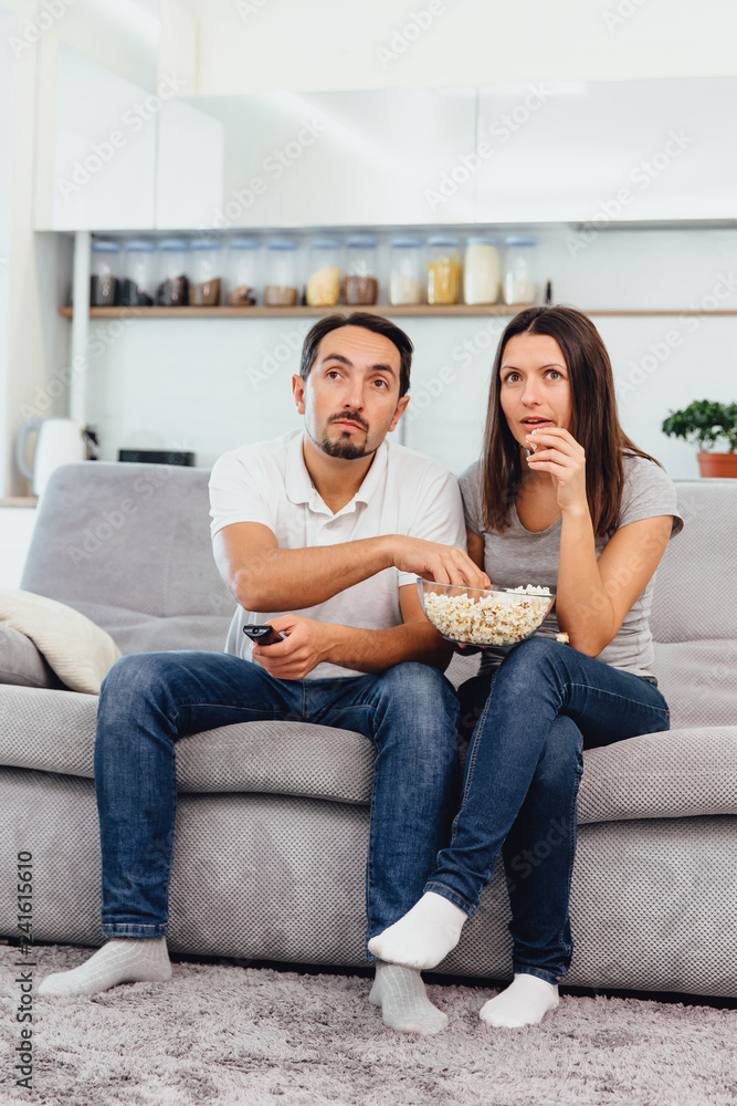 Husband and woman sitting on the couch Husband and woman sitting on the couch