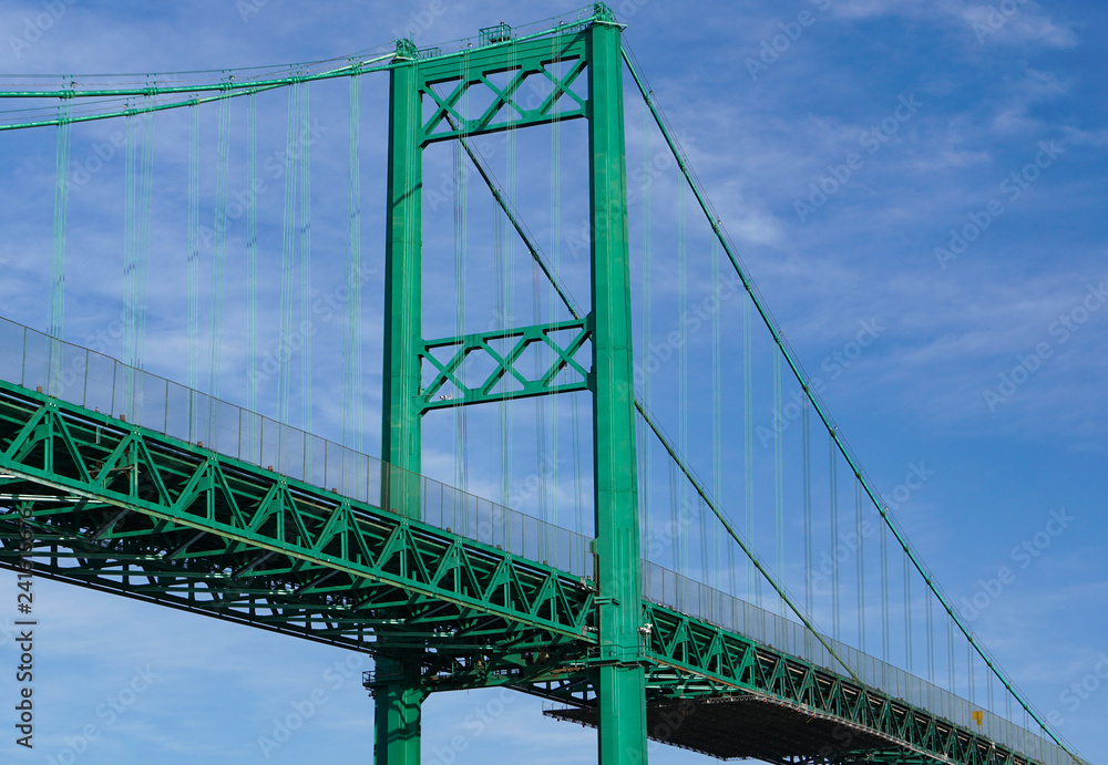 Fototapeta premium Vincent Thomas Suspension Bridge west tower in San Pedro California across the Port of Los Angeles, showing the cable system and roadway, 1500 feet long