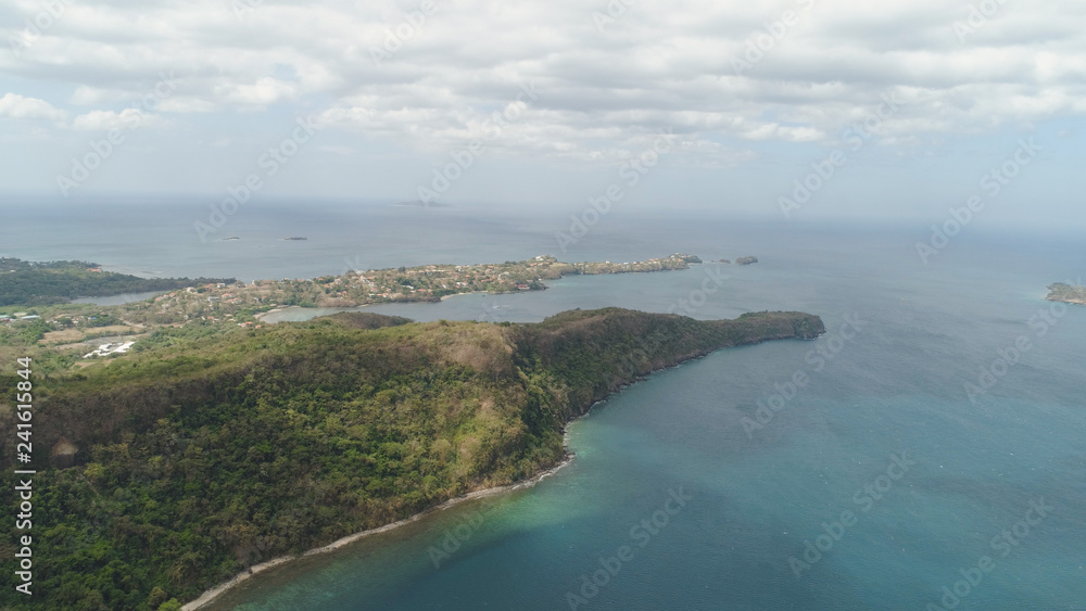 Aerial view of coast with beach, hotels. Philippines, Luzon. Coast ocean with tropical beach, turquoise water. Tropical landscape in Asia.