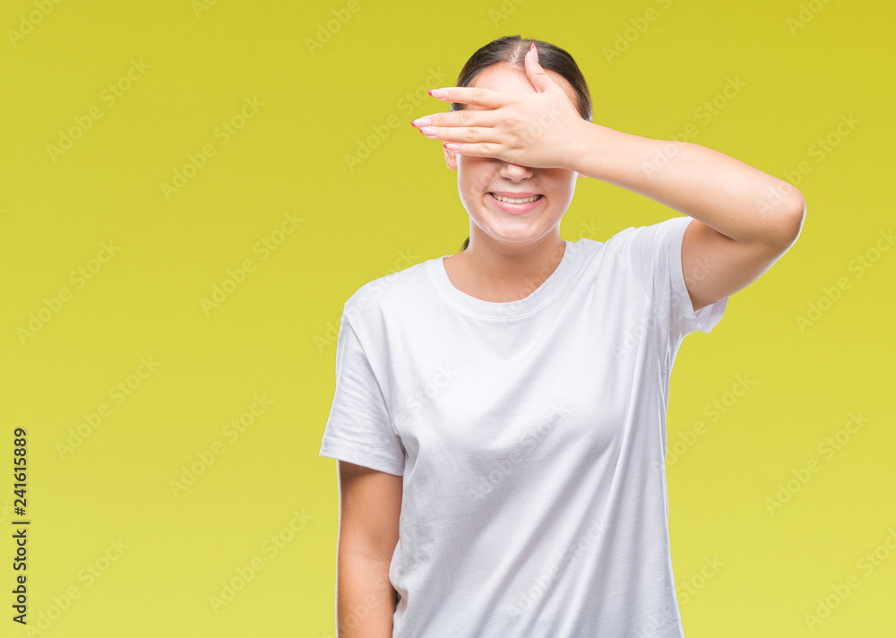 Young beautiful caucasian woman over isolated background smiling and laughing with hand on face covering eyes for surprise. Blind concept. Young beautiful caucasian woman over isolated background smiling and laughing with hand on face covering eyes for surprise. Blind concept.
