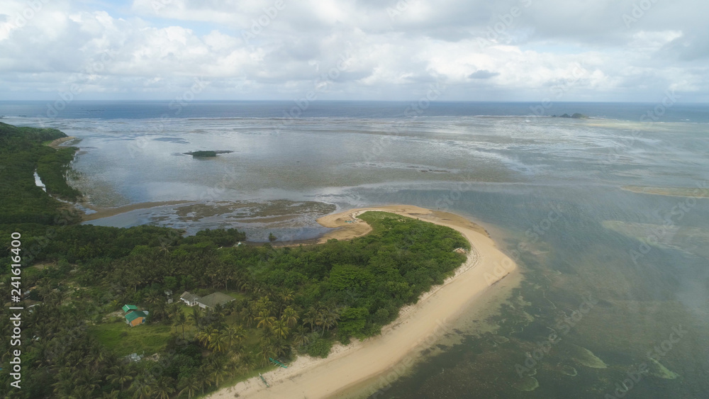Aerial view of beautiful tropical beach with turquoise water in blue lagoon, Punta verde, Philippines, Santa Ana. Ocean coastline, mountains covered rainforest. Tropical landscape in Asia. Aerial view of beautiful tropical beach with turquoise water in blue lagoon, Punta verde, Philippines, Santa Ana. Ocean coastline, mountains covered rainforest. Tropical landscape in Asia.