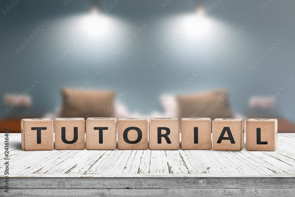 Tutorial sign on a wooden table in a room with lights - obrazy, fototapety, plakaty 