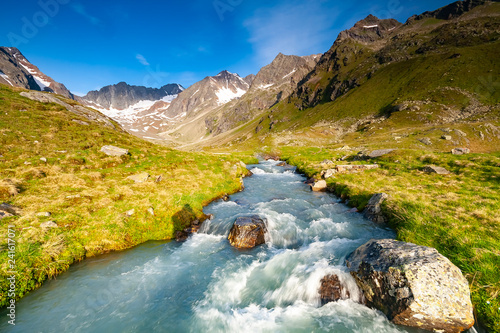 Fresh stream in river coming from glaciers up the valley near Neue Regensburger huette, Stubai Tyrol Alps, Austria photo