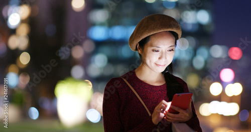 Photography Woman use of mobile phone in city at night