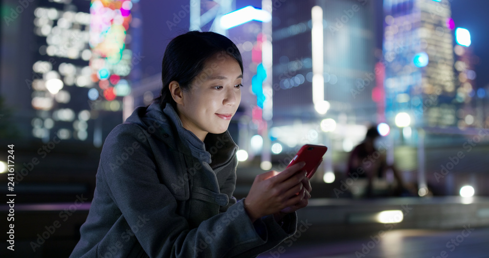 Woman use of mobile phone online at night Woman use of mobile phone online at night