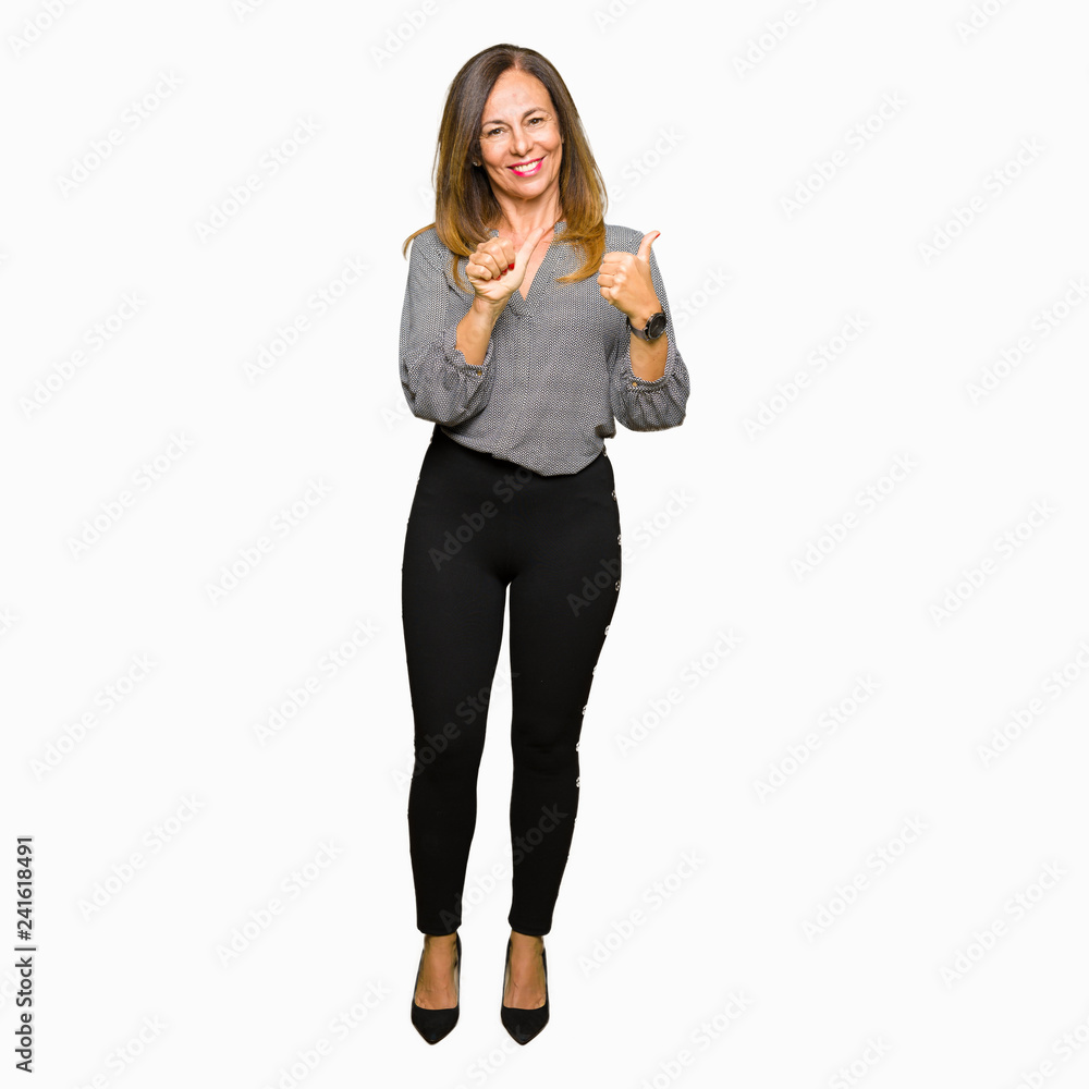 Beautiful middle age business woman Pointing to the back behind with hand and thumbs up, smiling confident Beautiful middle age business woman Pointing to the back behind with hand and thumbs up, smiling confident