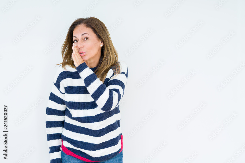 Beautiful middle age woman wearing navy sweater over isolated background hand on mouth telling secret rumor, whispering malicious talk conversation Beautiful middle age woman wearing navy sweater over isolated background hand on mouth telling secret rumor, whispering malicious talk conversation