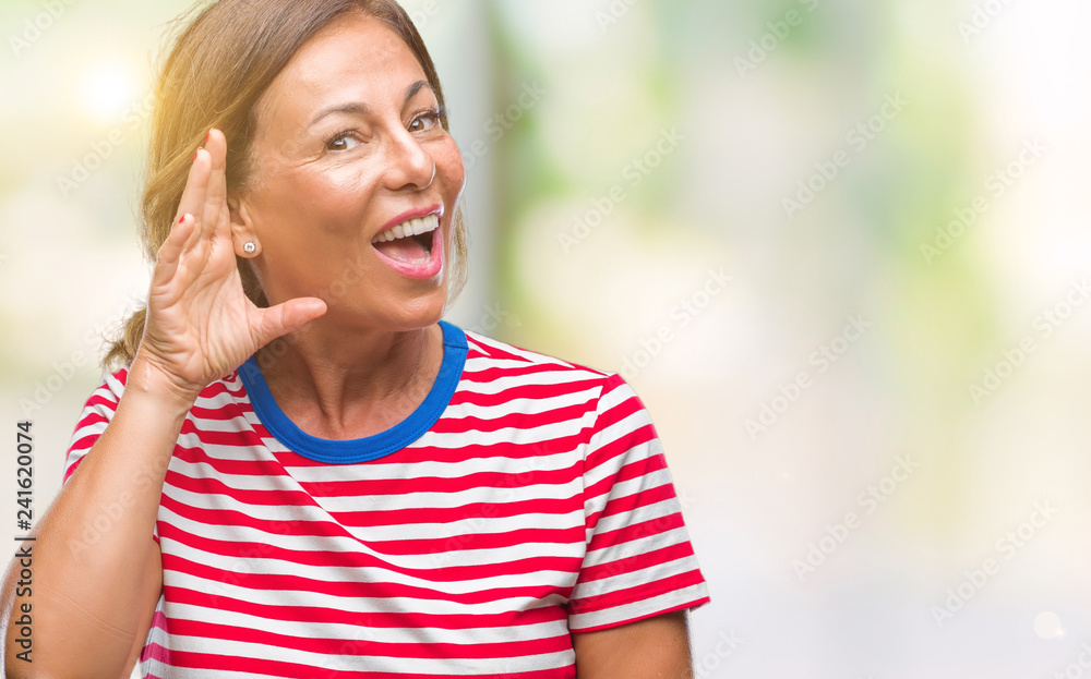 Middle age senior hispanic woman over isolated background smiling with hand over ear listening an hearing to rumor or gossip. Deafness concept. Middle age senior hispanic woman over isolated background smiling with hand over ear listening an hearing to rumor or gossip. Deafness concept.