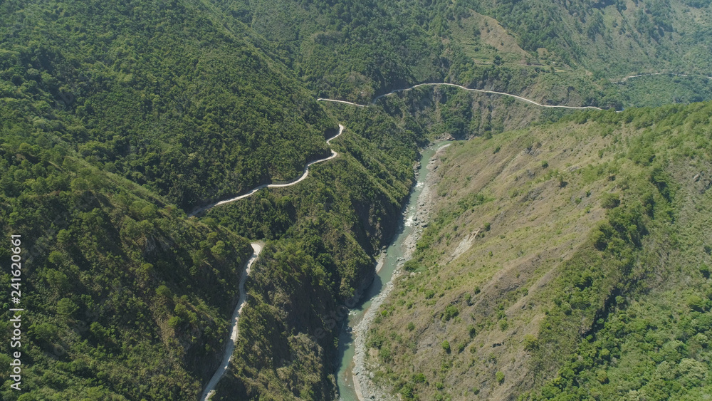 Aerial view of mountain river in the cordillera gorge, mountains covered forest, trees. Cordillera region. Luzon, Philippines. Mountain landscape.