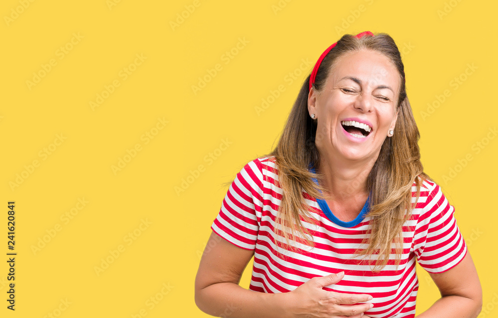 Beautiful middle age woman wearing casual stripes t-shirt over isolated background Smiling and laughing hard out loud because funny crazy joke. Happy expression. Beautiful middle age woman wearing casual stripes t-shirt over isolated background Smiling and laughing hard out loud because funny crazy joke. Happy expression.