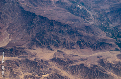 Aerial view of the mountains of Peru, seen from a plane window. Dry land and hills. photo