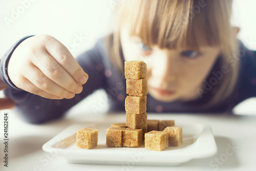 Child, sugar cubes. The problem of excessive consumption of sugar by children under the age of 10 years.