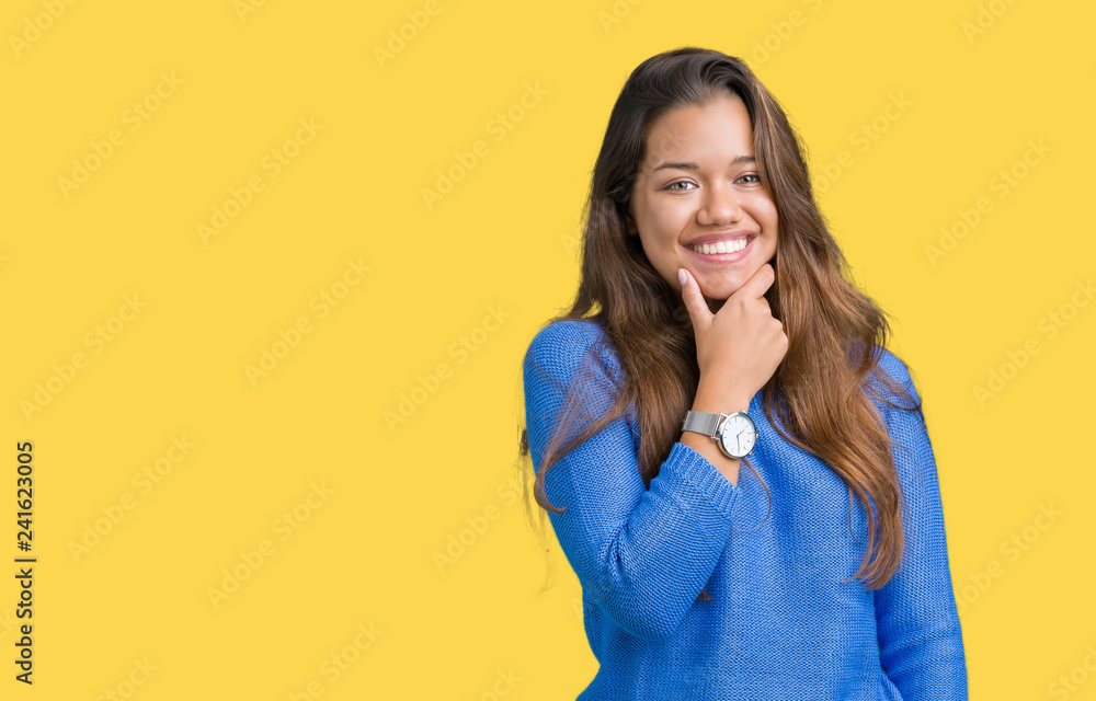Young beautiful brunette woman wearing blue sweater over isolated background looking confident at the camera with smile with crossed arms and hand raised on chin. Thinking positive. Young beautiful brunette woman wearing blue sweater over isolated background looking confident at the camera with smile with crossed arms and hand raised on chin. Thinking positive.
