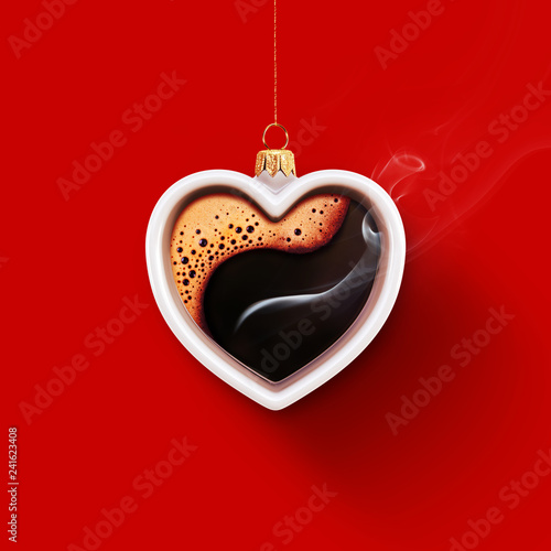 Christmas toy is made from a fragrant cup of coffee. Christmas toy. Holiday concept. Cup in the shape of a heart on a red background for your design. Advertising coffee.
