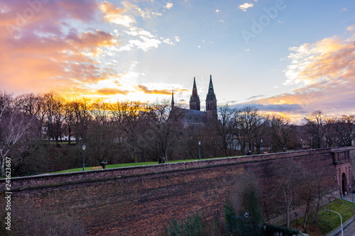 Prague, Czech republic: Panorama of Vysehrad basilica during the sunset. Orange clouds above the ancient church in czech capital