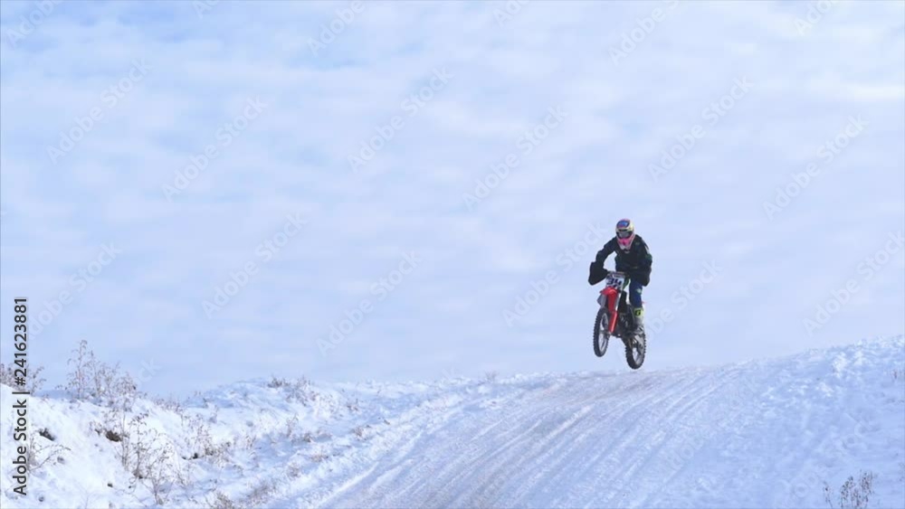 Motorcycles, Children bikers rider on snowy motocross track. Rider on snow. Motocross rider on bike, motocross winter season race. Racer motorcycle rides on motocross snowy track in winter. Motorcycles, Children bikers rider on snowy motocross track. Rider on snow. Motocross rider on bike, motocross winter season race. Racer motorcycle rides on motocross snowy track in winter.