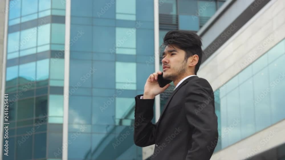Asian man making business calls Asian man making business calls