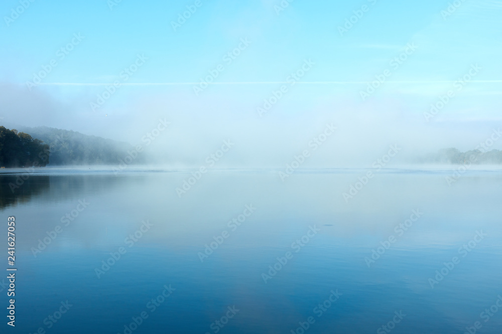 Morning fog on the lake on a summer day
