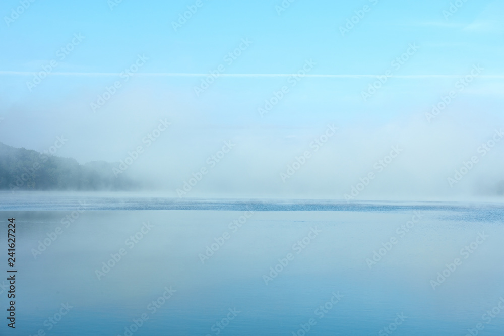 Fototapeta premium Morning fog on the lake on a summer day