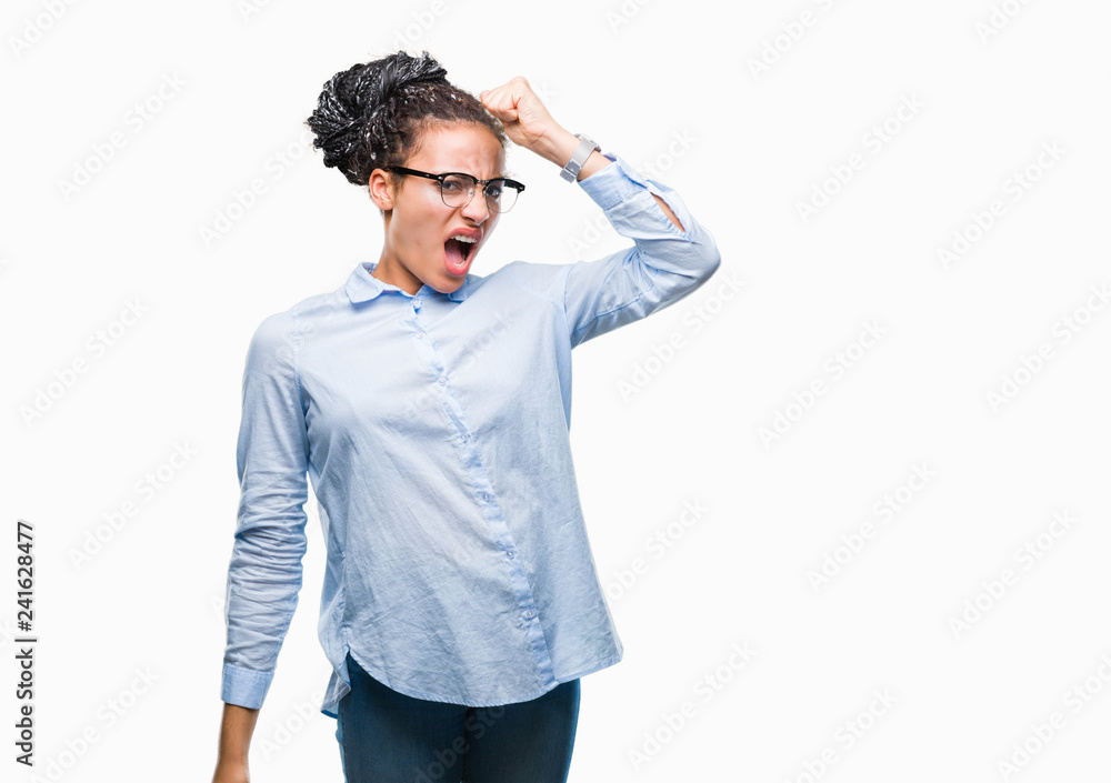 Young braided hair african american business girl wearing glasses over isolated background angry and mad raising fist frustrated and furious while shouting with anger. Rage and aggressive concept. Young braided hair african american business girl wearing glasses over isolated background angry and mad raising fist frustrated and furious while shouting with anger. Rage and aggressive concept.