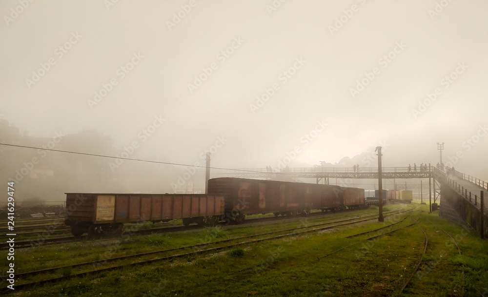 Fog covering Paranapiacaba's village, with wagons and railway in foreground and the footbridge in background Fog covering Paranapiacaba's village, with wagons and railway in foreground and the footbridge in background