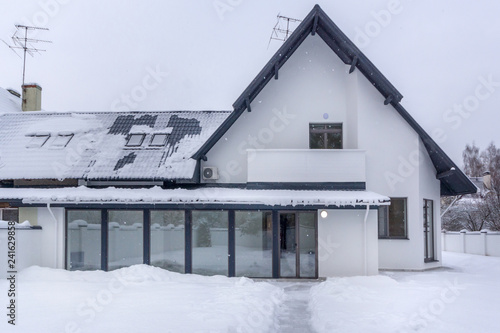 Residential house in frosty winter time covered with snow photo