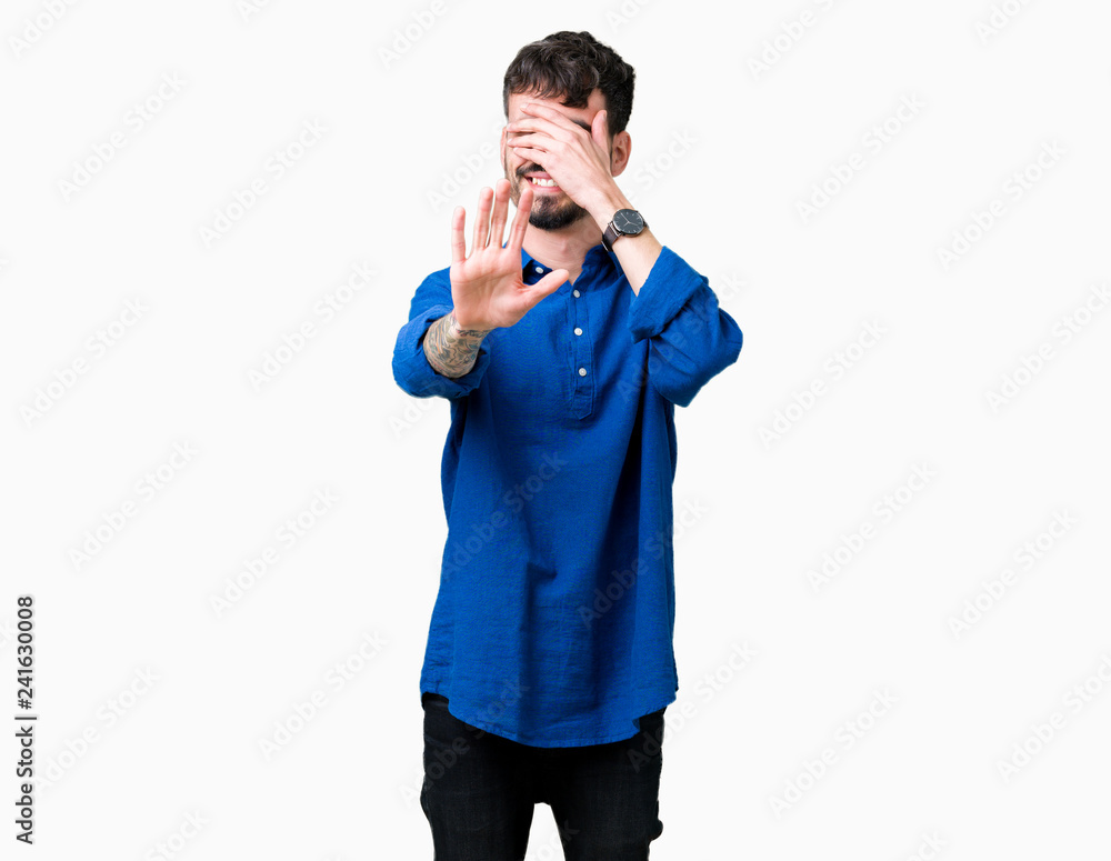 Young handsome man over isolated background covering eyes with hands and doing stop gesture with sad and fear expression. Embarrassed and negative concept. Young handsome man over isolated background covering eyes with hands and doing stop gesture with sad and fear expression. Embarrassed and negative concept.