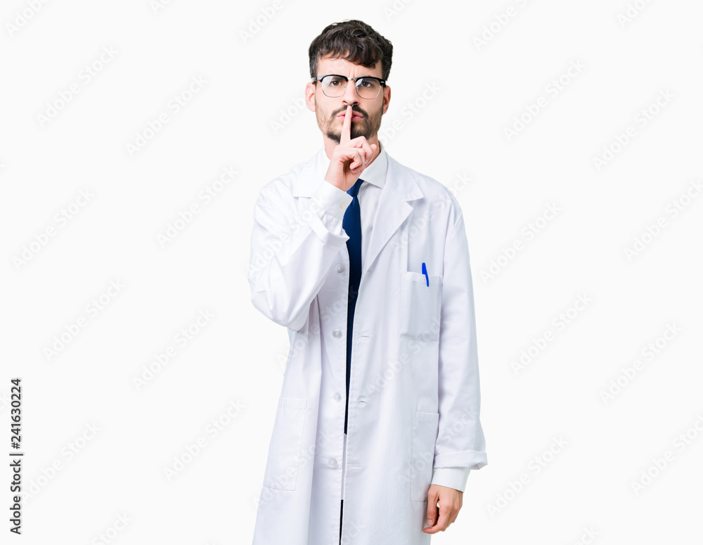 Young professional scientist man wearing white coat over isolated background asking to be quiet with finger on lips. Silence and secret concept.