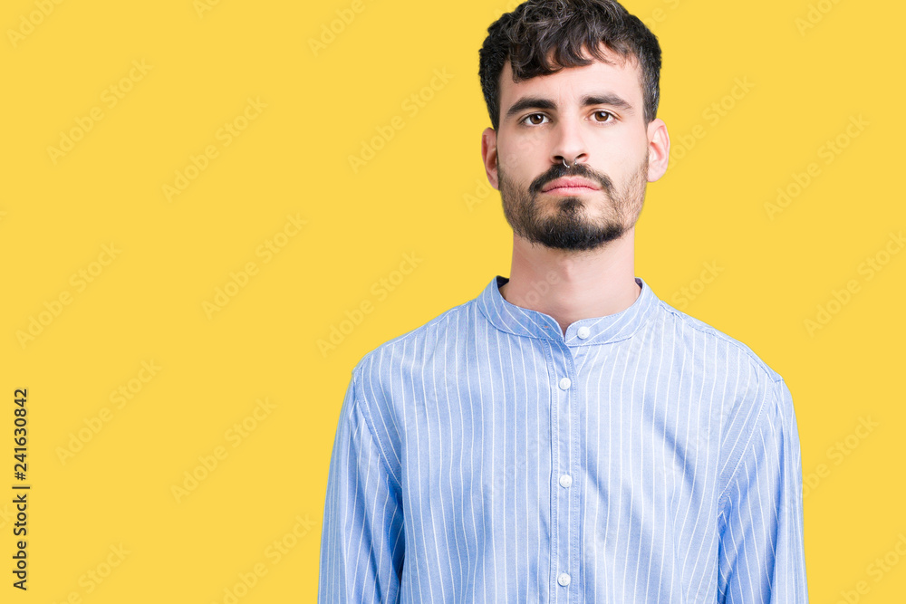Young handsome business man over isolated background with serious expression on face. Simple and natural looking at the camera. Young handsome business man over isolated background with serious expression on face. Simple and natural looking at the camera.