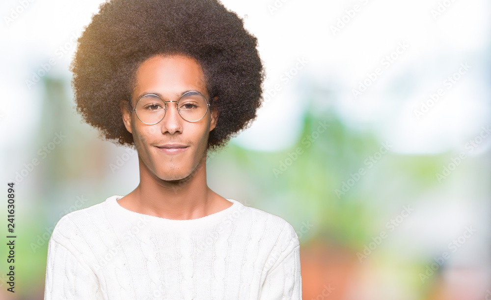 Young african american man with afro hair wearing glasses Smiling with hands palms together receiving or giving gesture. Hold and protection Young african american man with afro hair wearing glasses Smiling with hands palms together receiving or giving gesture. Hold and protection