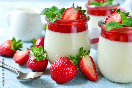 Vanilla panna cotta with strawberry jelly in a vintage jar, traditional italian dessert.