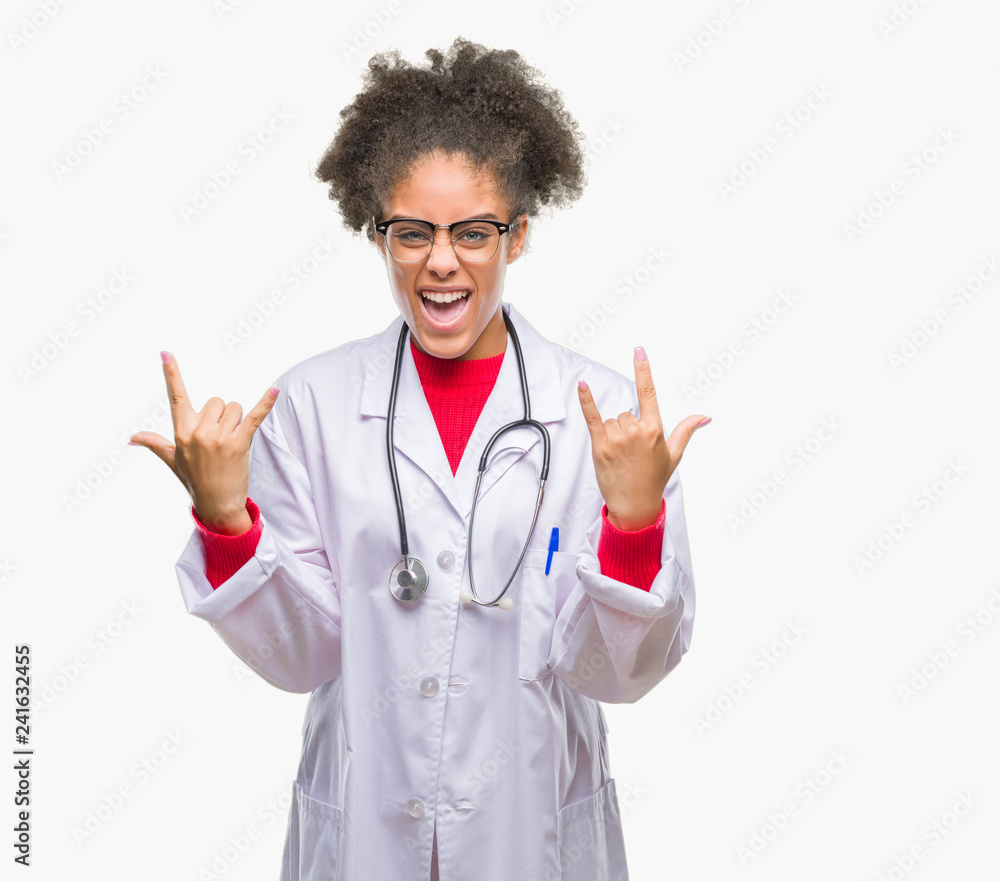 Young afro american doctor woman over isolated background shouting with crazy expression doing rock symbol with hands up. Music star. Heavy concept. Young afro american doctor woman over isolated background shouting with crazy expression doing rock symbol with hands up. Music star. Heavy concept.
