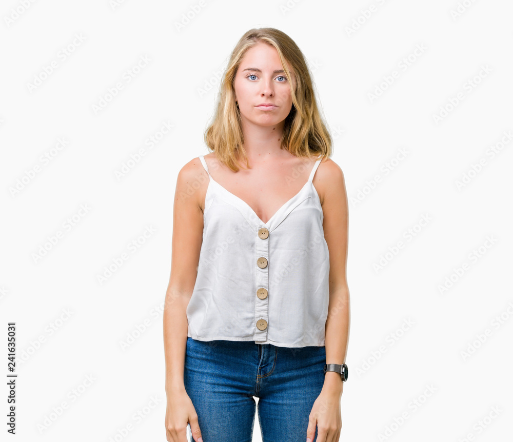 Obraz premium Beautiful young woman over isolated background with serious expression on face. Simple and natural looking at the camera.