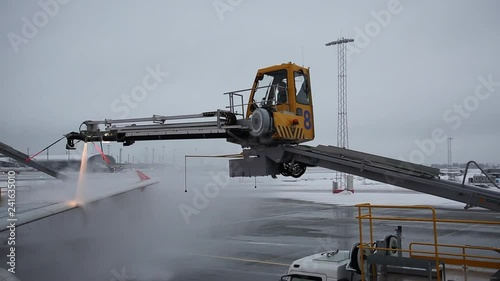 Oslo Gardermoen Airport (Norwegian: Oslo Lufthavn, OSL, ENGM) Norway, December 2018, aircraft wing deicing before departure during winter season photo