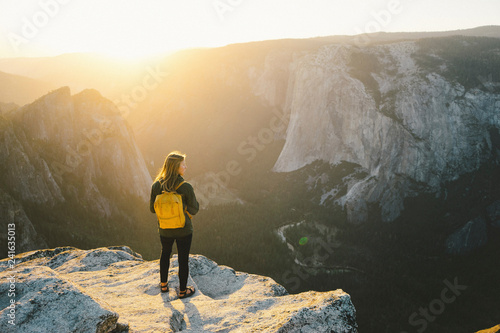 Rear view of female hiker standing on cliff at Yosemite National Park photo